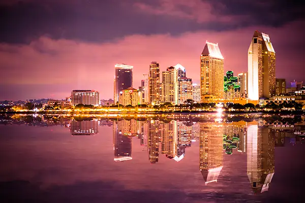 City skyline reflected in water.